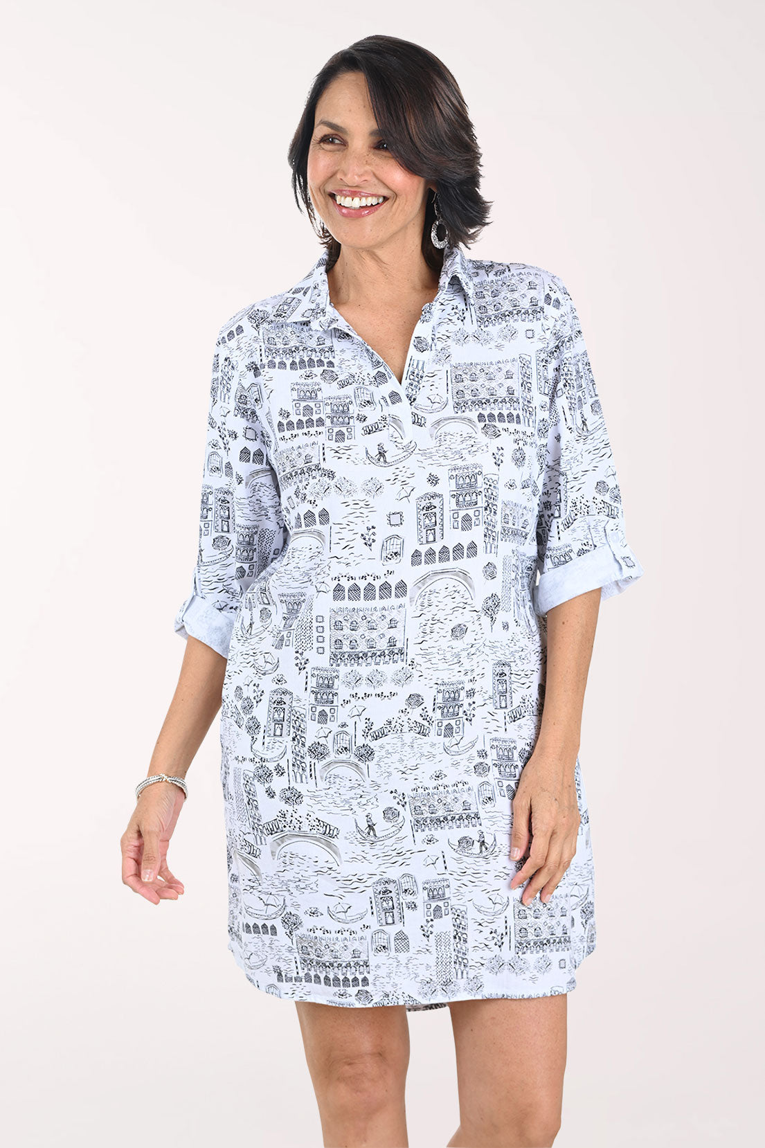 Woman wearing a white dress with black text pattern on a white background