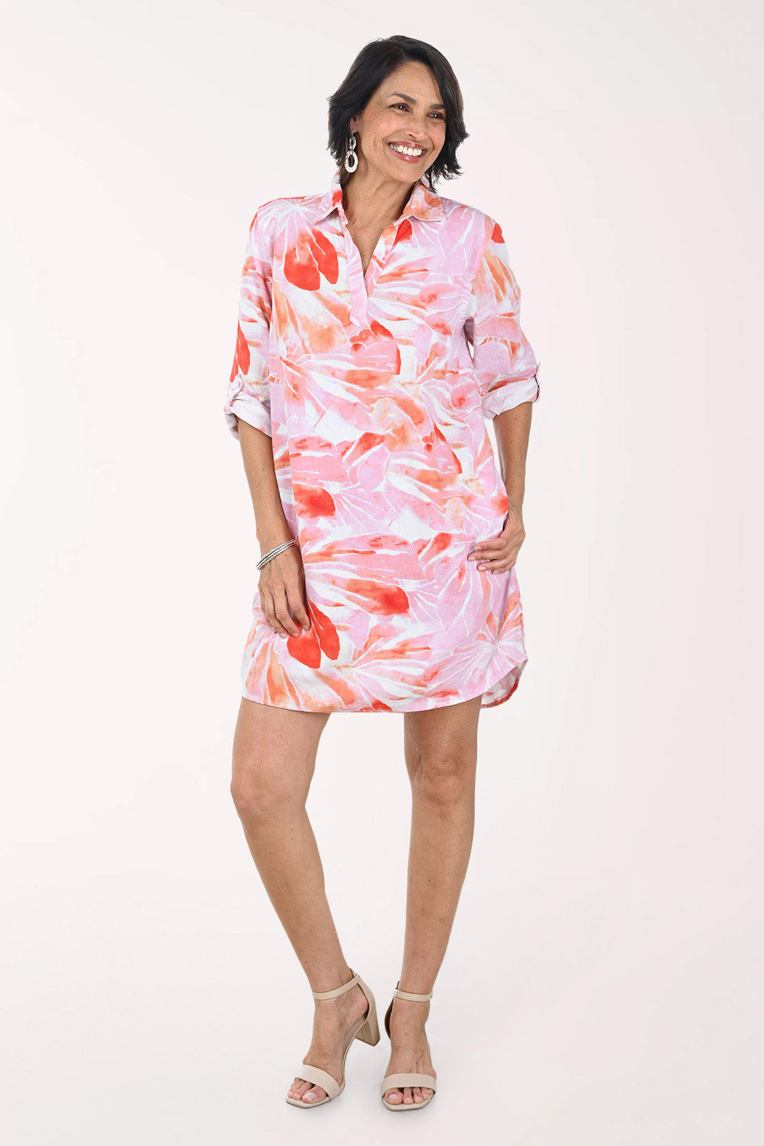 Woman wearing a pink floral dress on a white background
