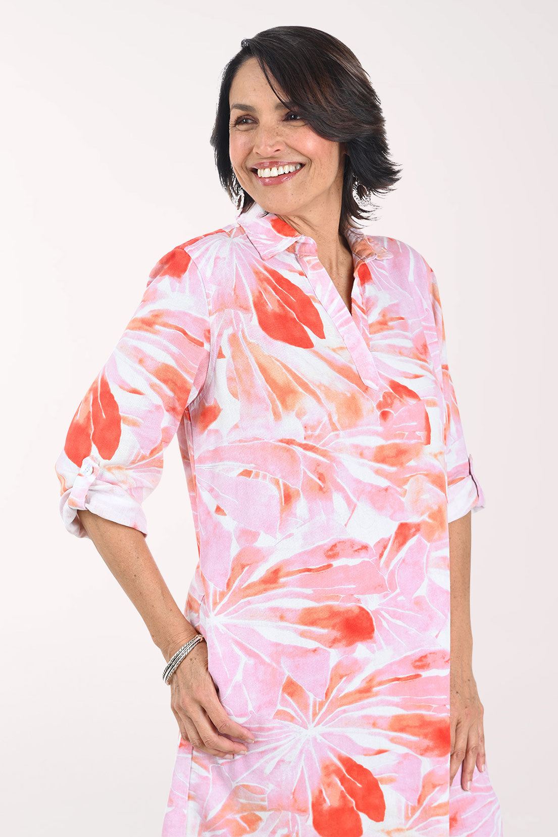 Woman wearing a pink floral dress on a white background