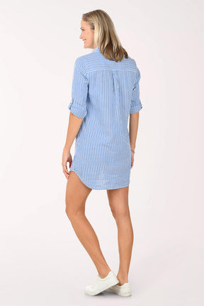 Woman wearing a blue and white striped shirt dress on a white background