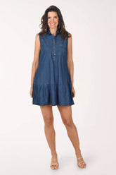 Woman wearing a blue denim dress on a white background