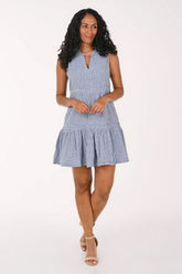 Woman wearing a blue striped dress on a white background