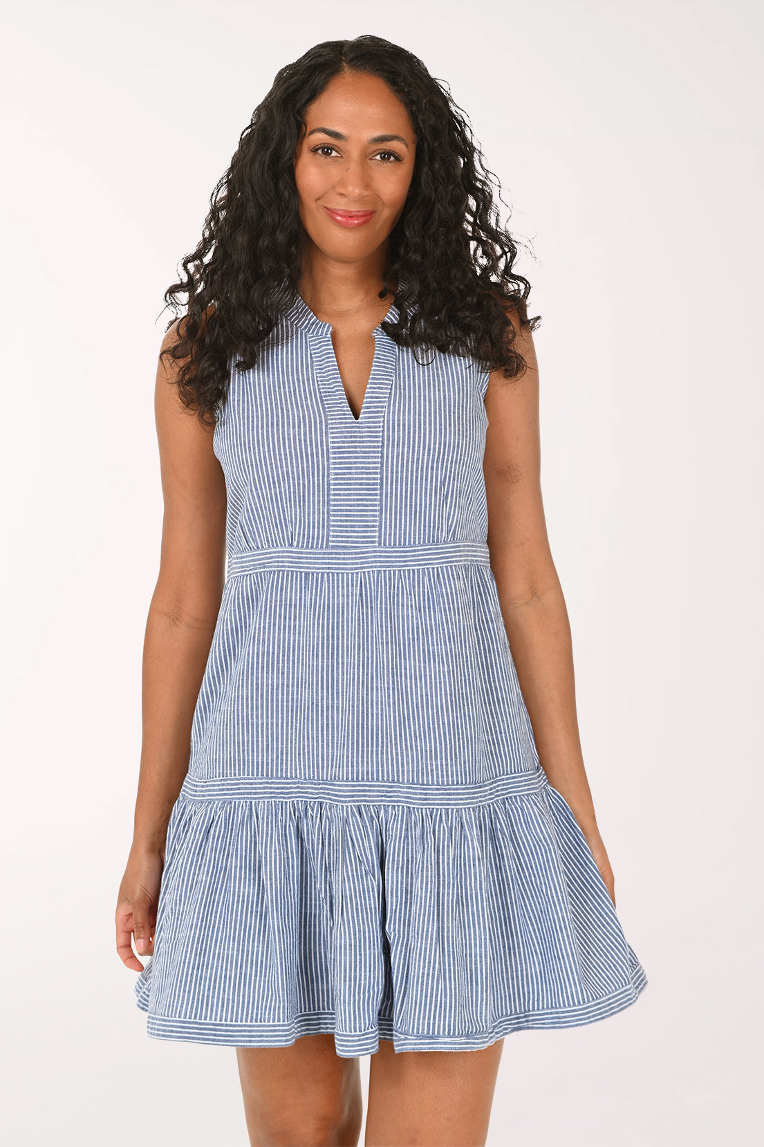Woman wearing a blue striped dress on a white background