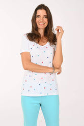 Front shot of model wearing a white tee with multi color stars