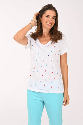 Front shot of model wearing a white tee with multi color stars