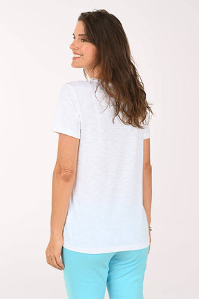 Back shot of model wearing a white tee with multi color stars