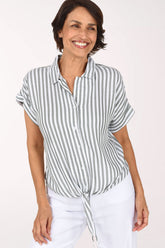 Woman wearing a seersucker olive green and white button down shirt with short sleeves and a tie bottom 