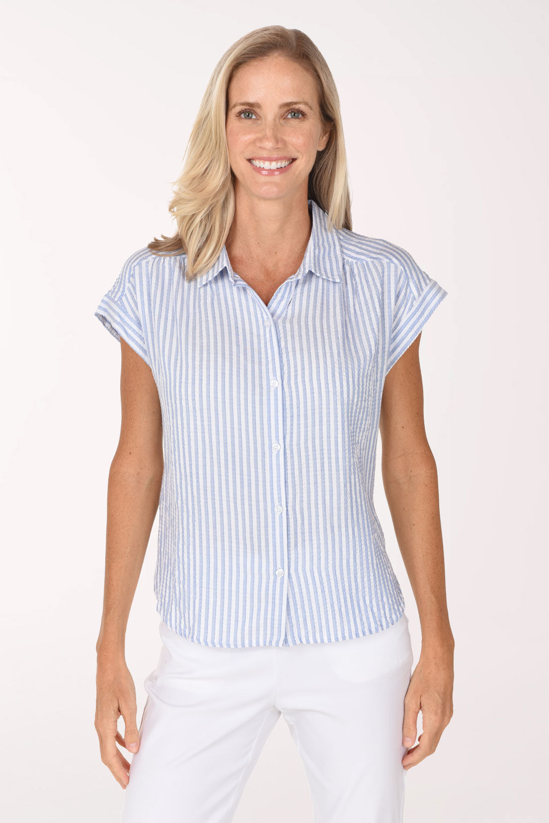 Woman wearing a cap sleeve button up shirt with a seersucker blue and white stripe pattern