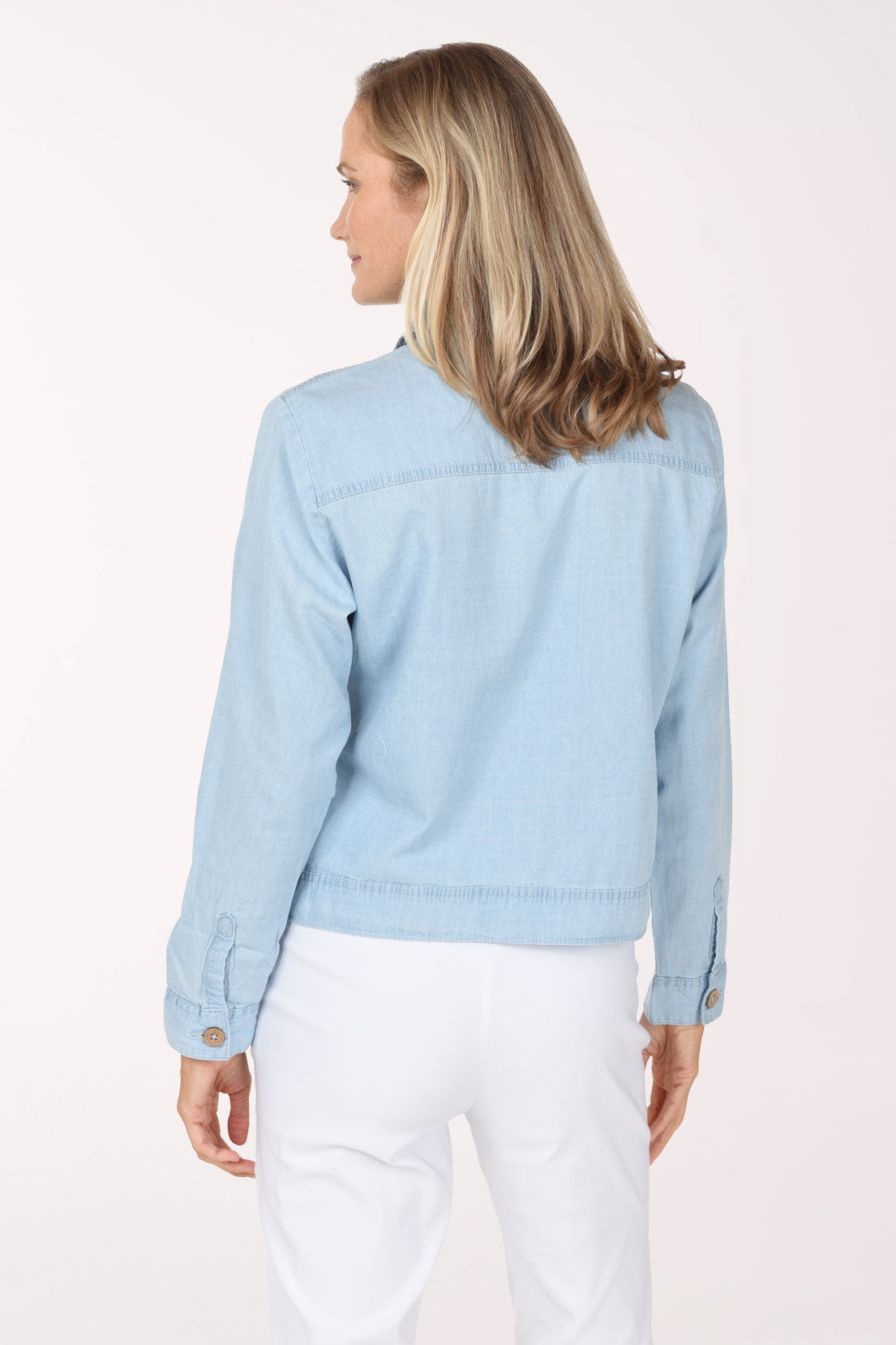 Woman wearing a light wash denim jacket