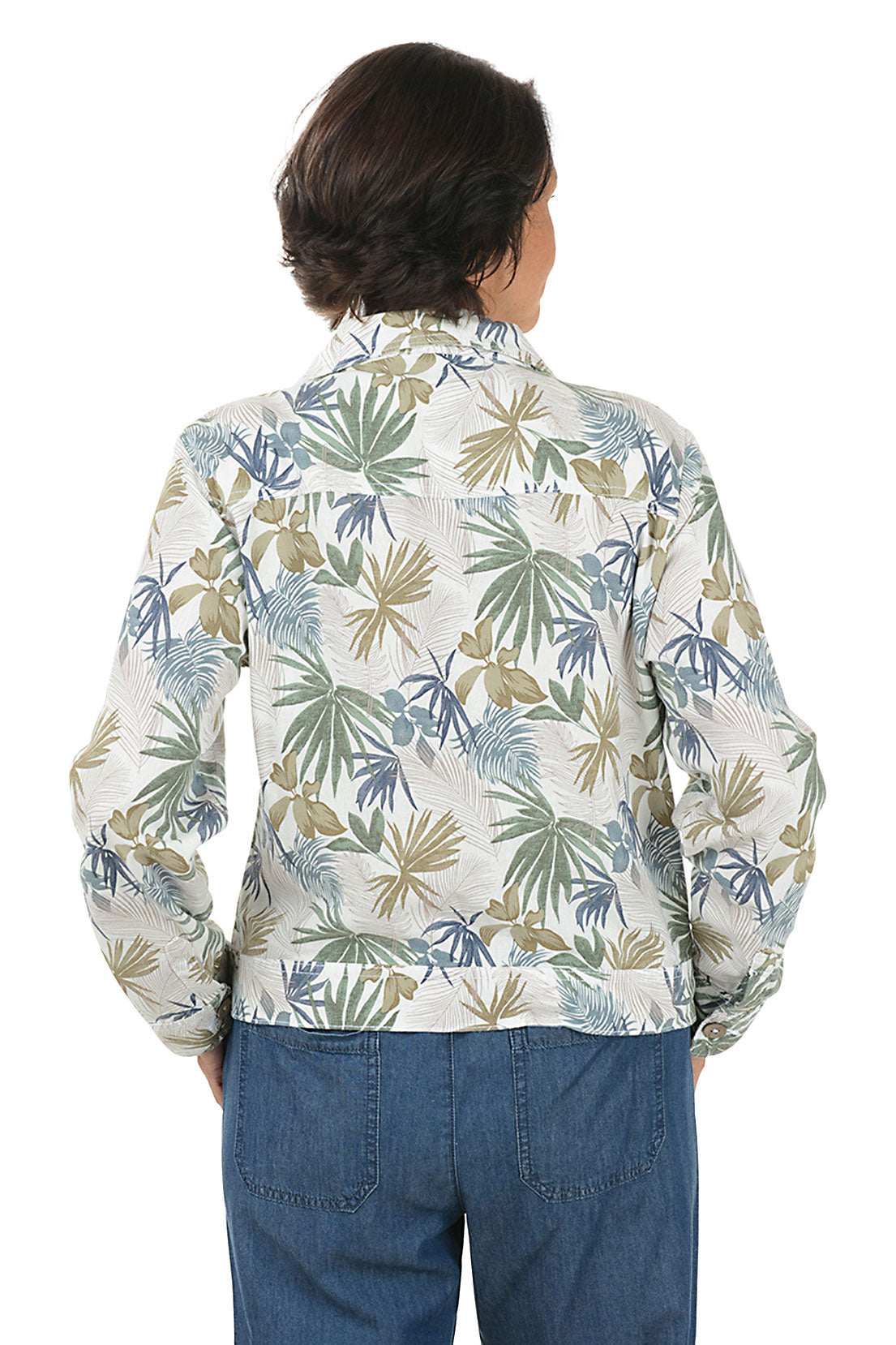 Woman wearing a floral patterned jacket and blue pants on a white background. Back shot.