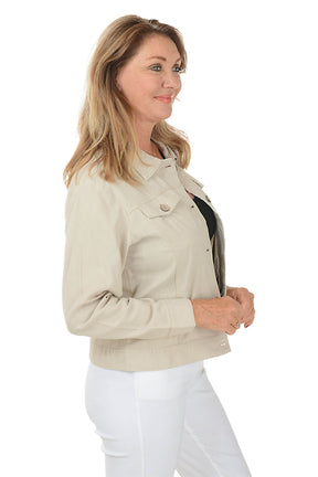 A side shot of a model wearing a sand button-front linen-blend jacket with a classic foldover collar and long sleeves with button cuffs. She is also wearing white pants.