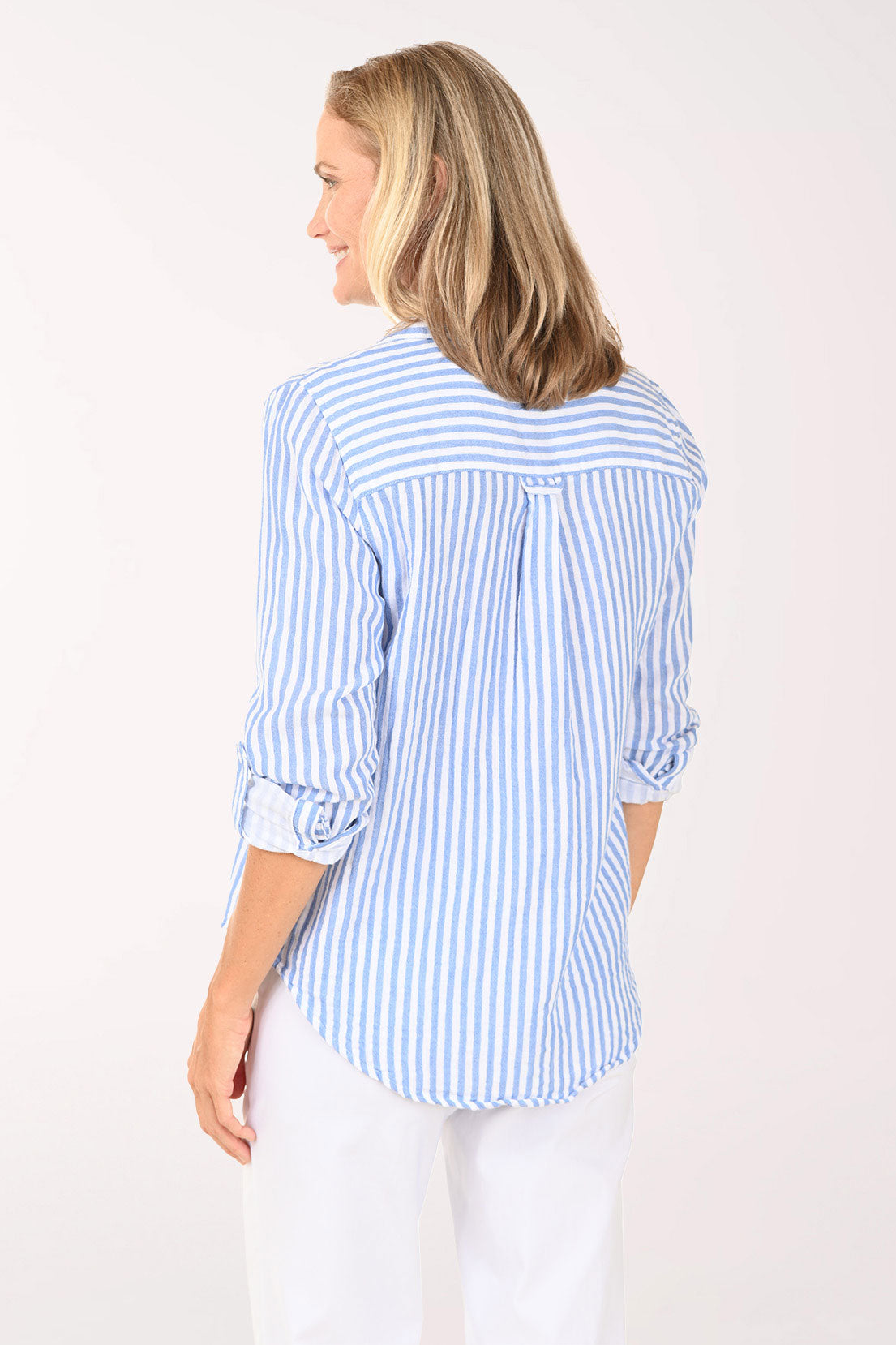 Woman wearing a blue and white striped roll sleeve shirt