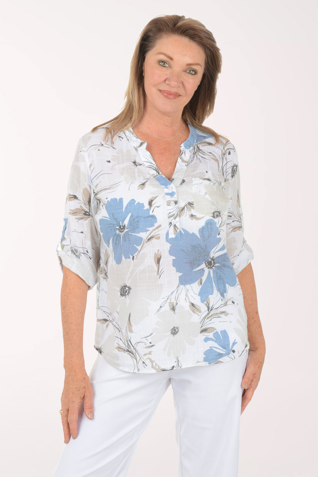 Woman wearing a floral blouse with blue flowers on a white background