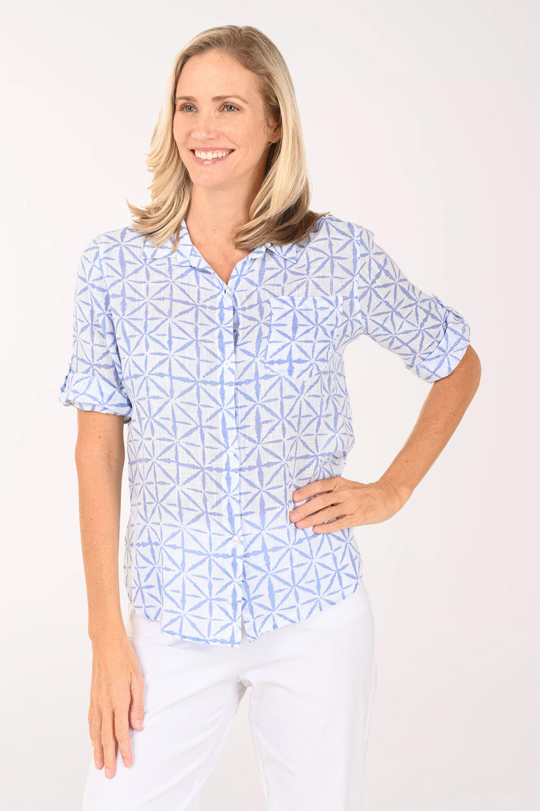 Woman wearing a blue and white button down top.