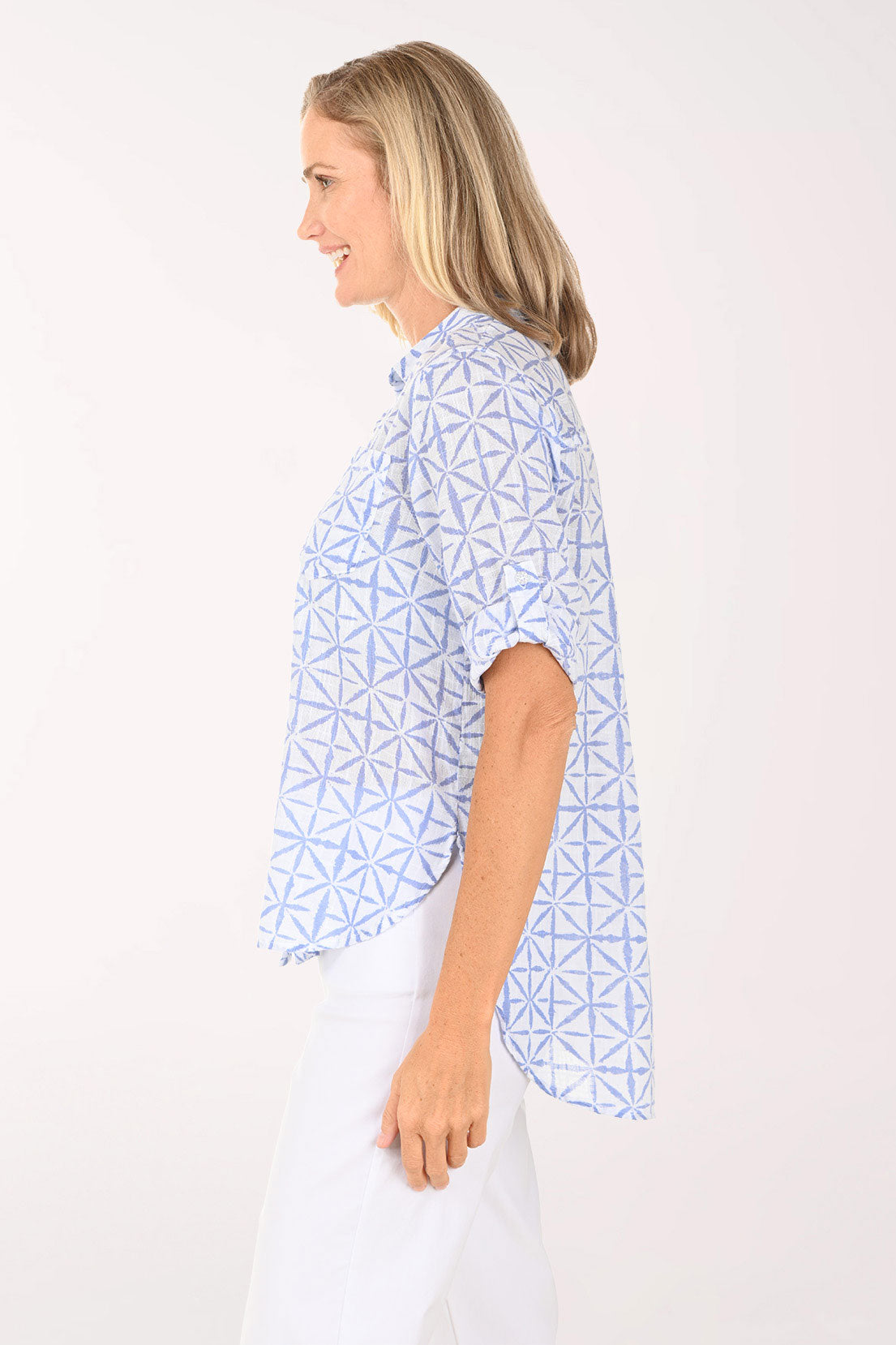 Woman wearing a blue and white button down top.