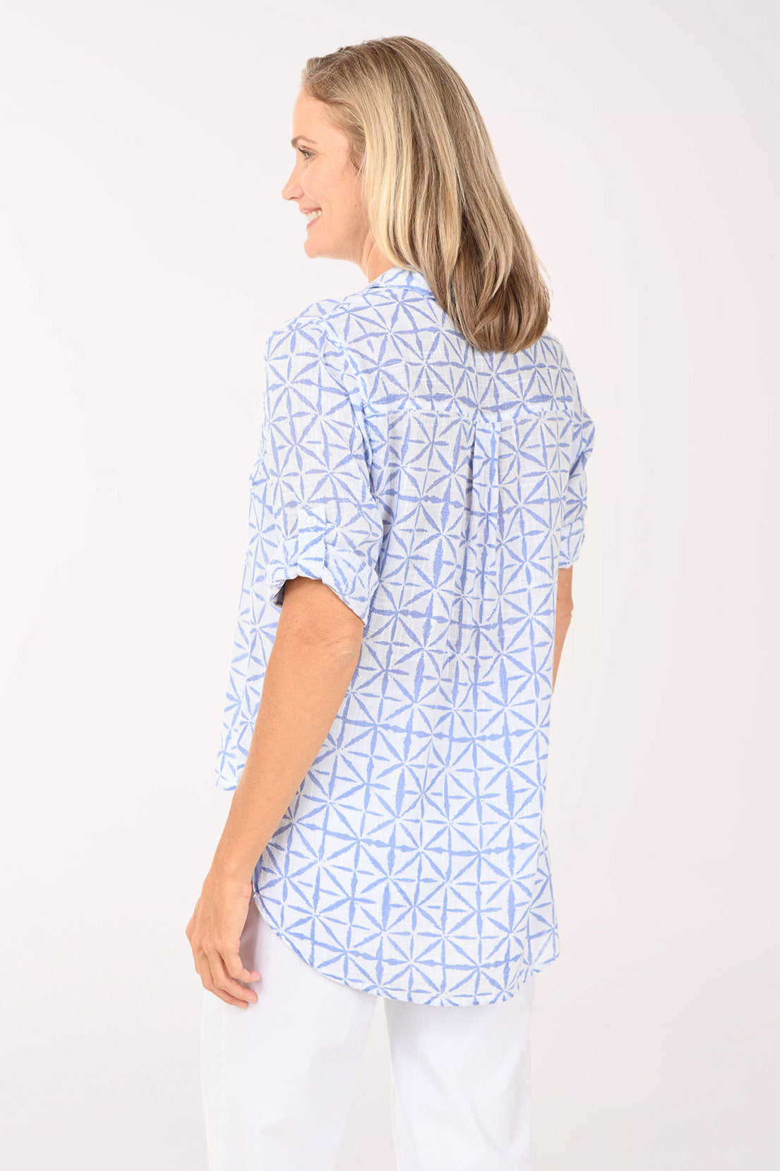 Woman wearing a blue and white button down top.