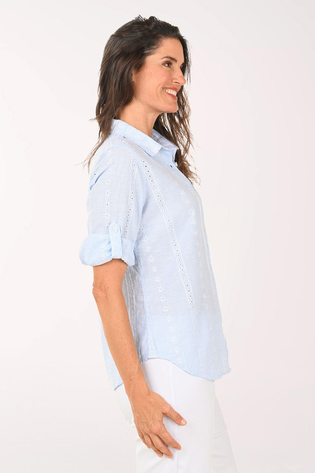 Woman wearing a chambray roll sleeve top.