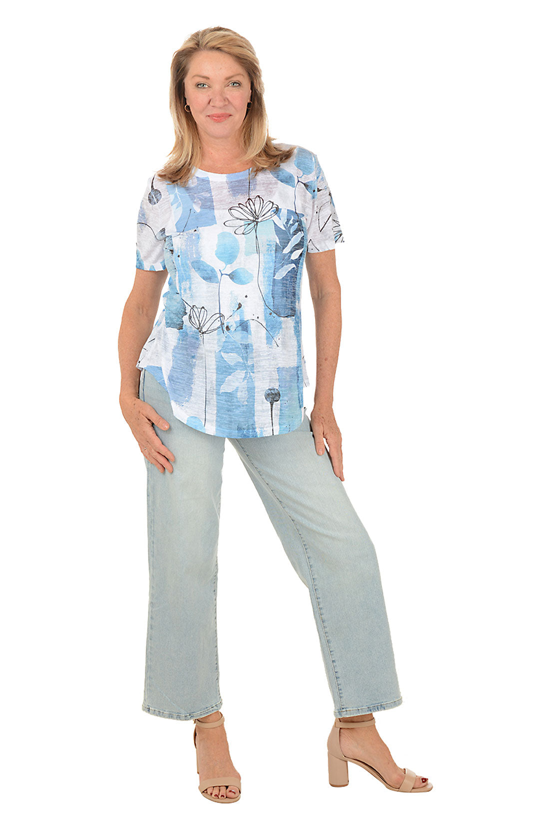 Woman wearing a blue floral blouse and light blue pants on a white background