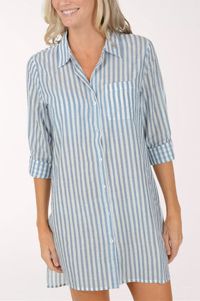 Woman wearing a blue and white striped shirt dress on a white background