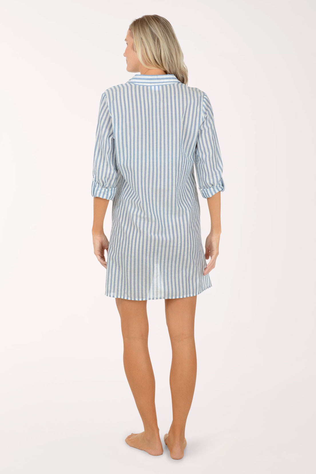 Woman wearing a blue and white striped shirt dress on a white background