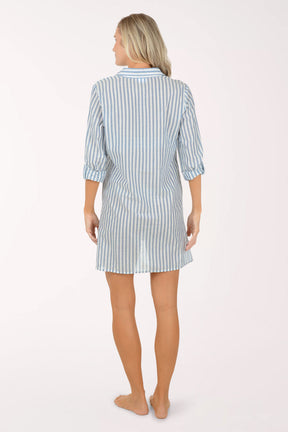 Woman wearing a blue and white striped shirt dress on a white background