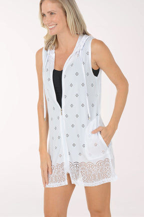 Woman wearing a white sleeveless top with lace trim on a white background