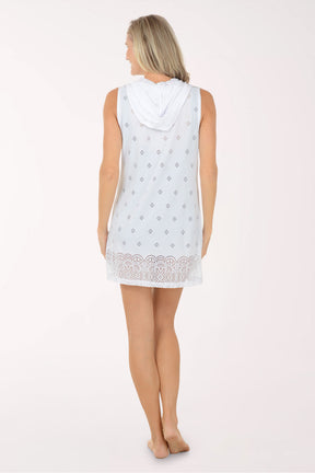 Woman wearing a white sleeveless top with lace trim on a white background