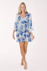 Woman wearing a blue floral dress on a white background
