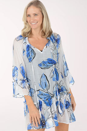 Woman wearing a blue floral dress on a white background
