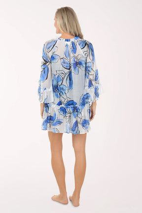 Woman wearing a blue floral dress on a white background
