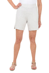 Person wearing light grey shorts on a white background.