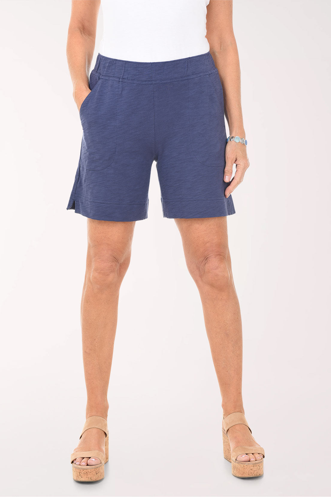 Person wearing blue shorts on a white background