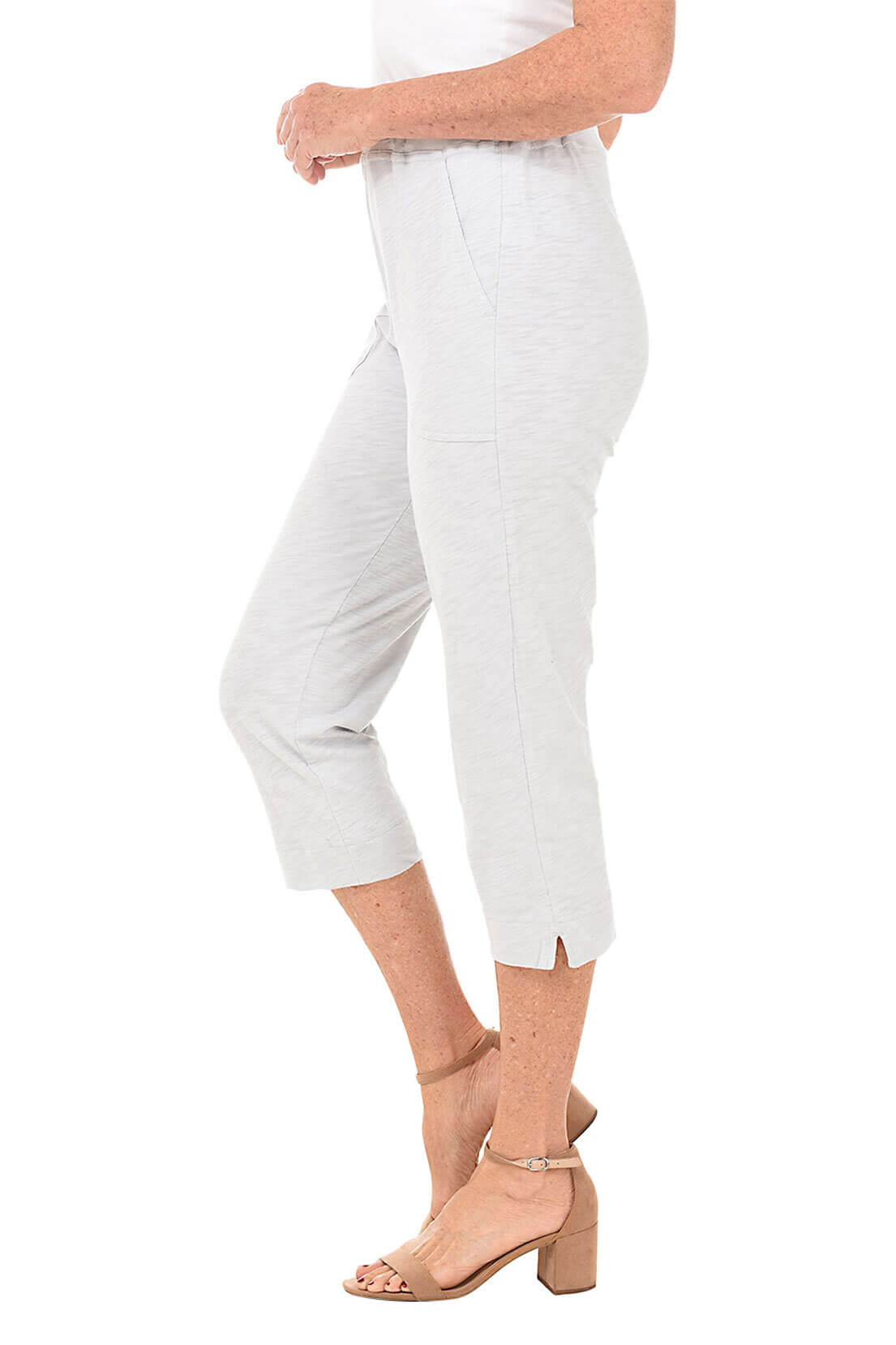 Light grey capri pants worn by a person on a white background- side shot