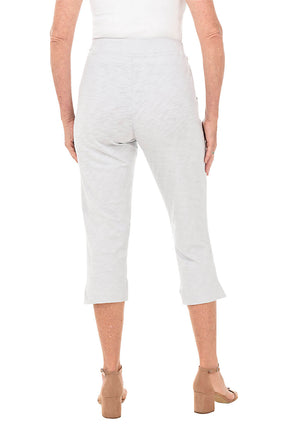 Light grey capri pants worn by a person on a white background- back shot