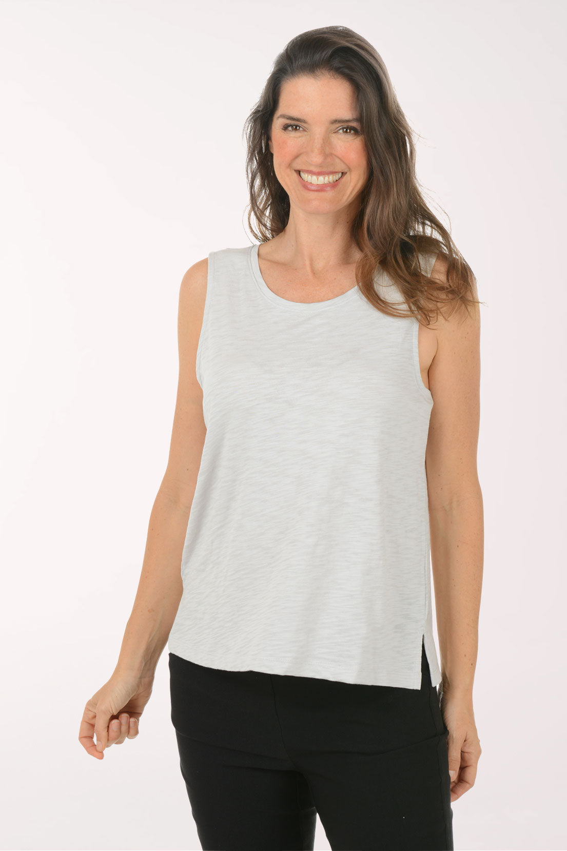 A woman wearing a sleeveless grey top.