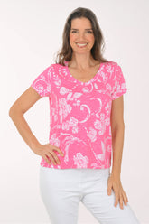 A woman wearing a short sleeve pink top.