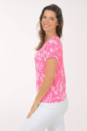 A woman wearing a short sleeve pink top.