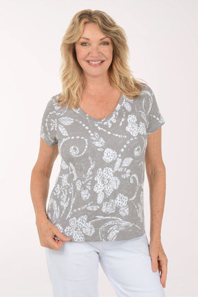 A woman wearing a short sleeve grey top.