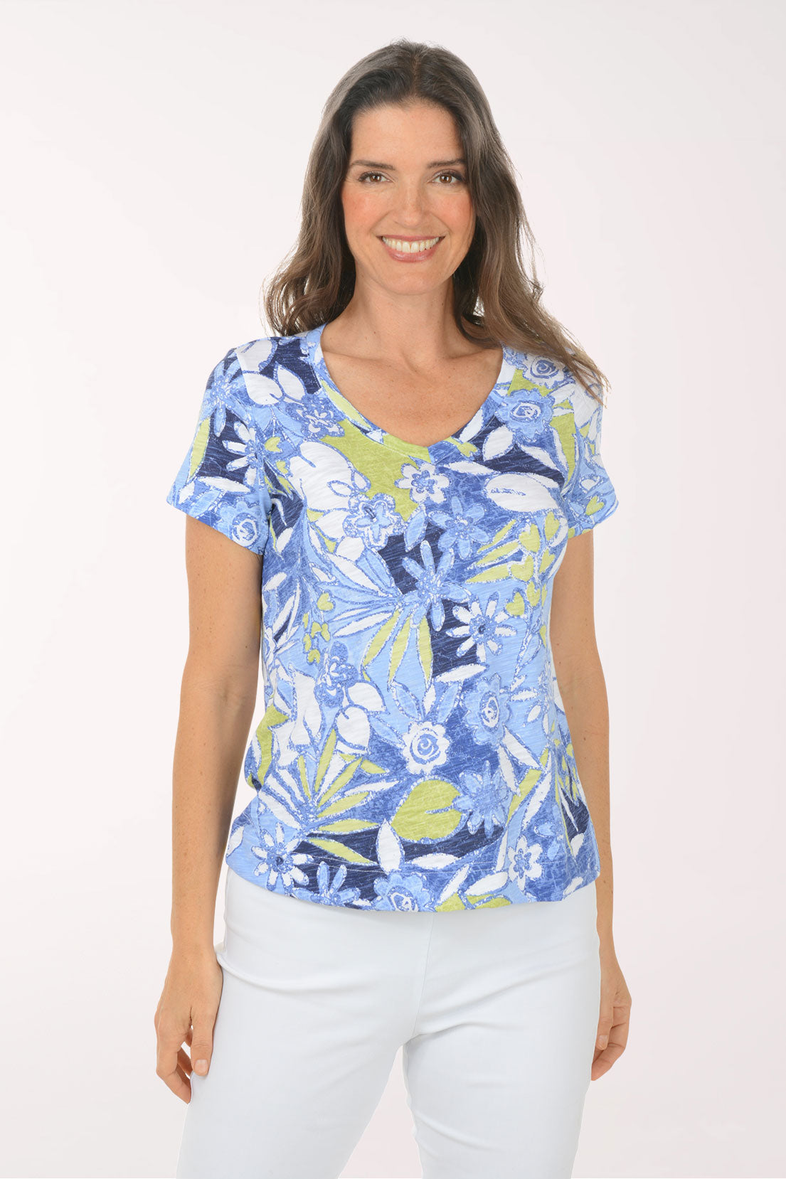 A woman wearing a short sleeve multicolored blue  top.