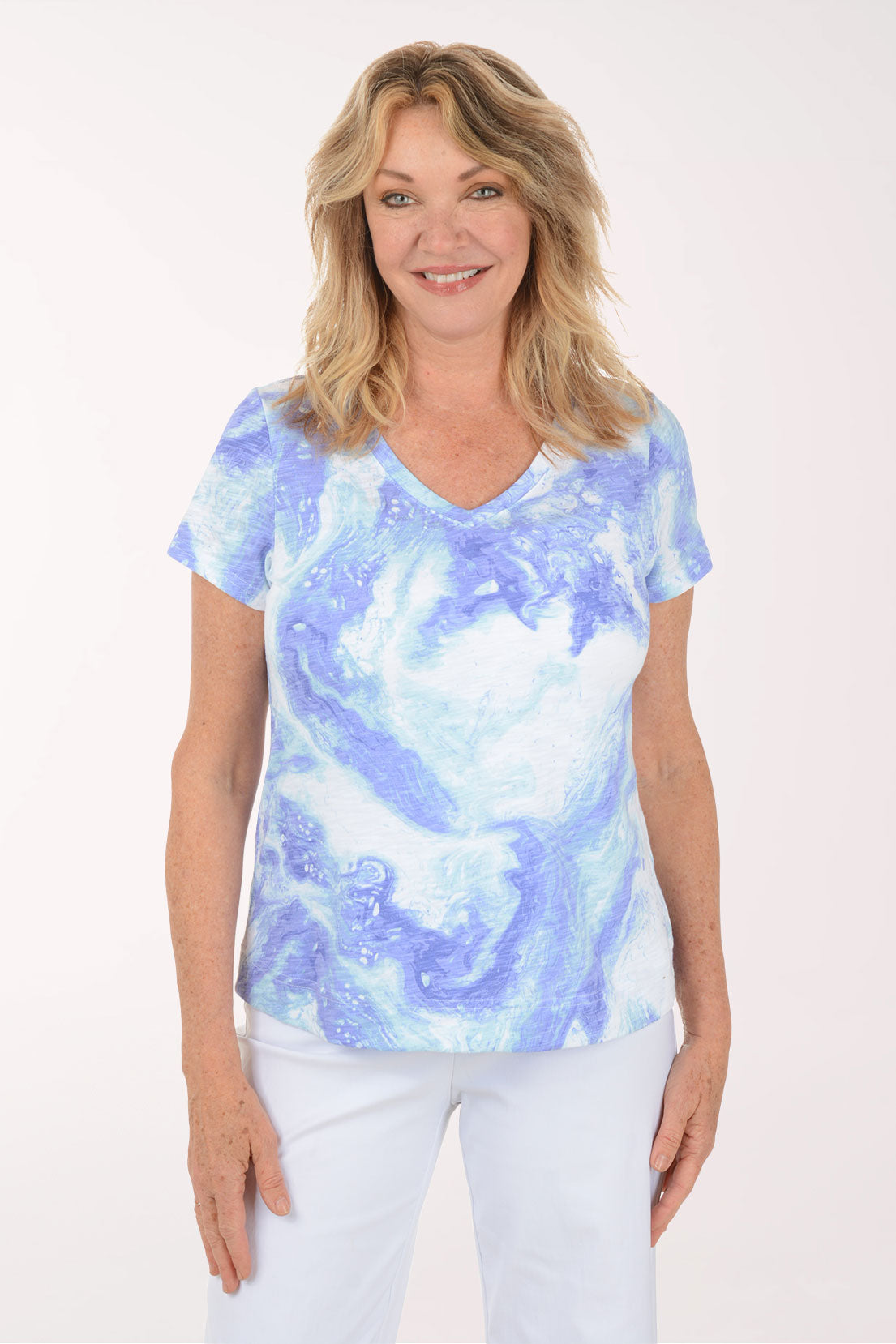 A woman wearing a short sleeve blue and white top.
