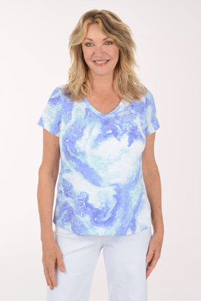 A woman wearing a short sleeve blue and white top.