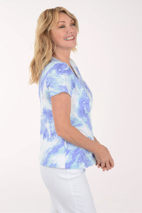 A woman wearing a short sleeve blue and white top.