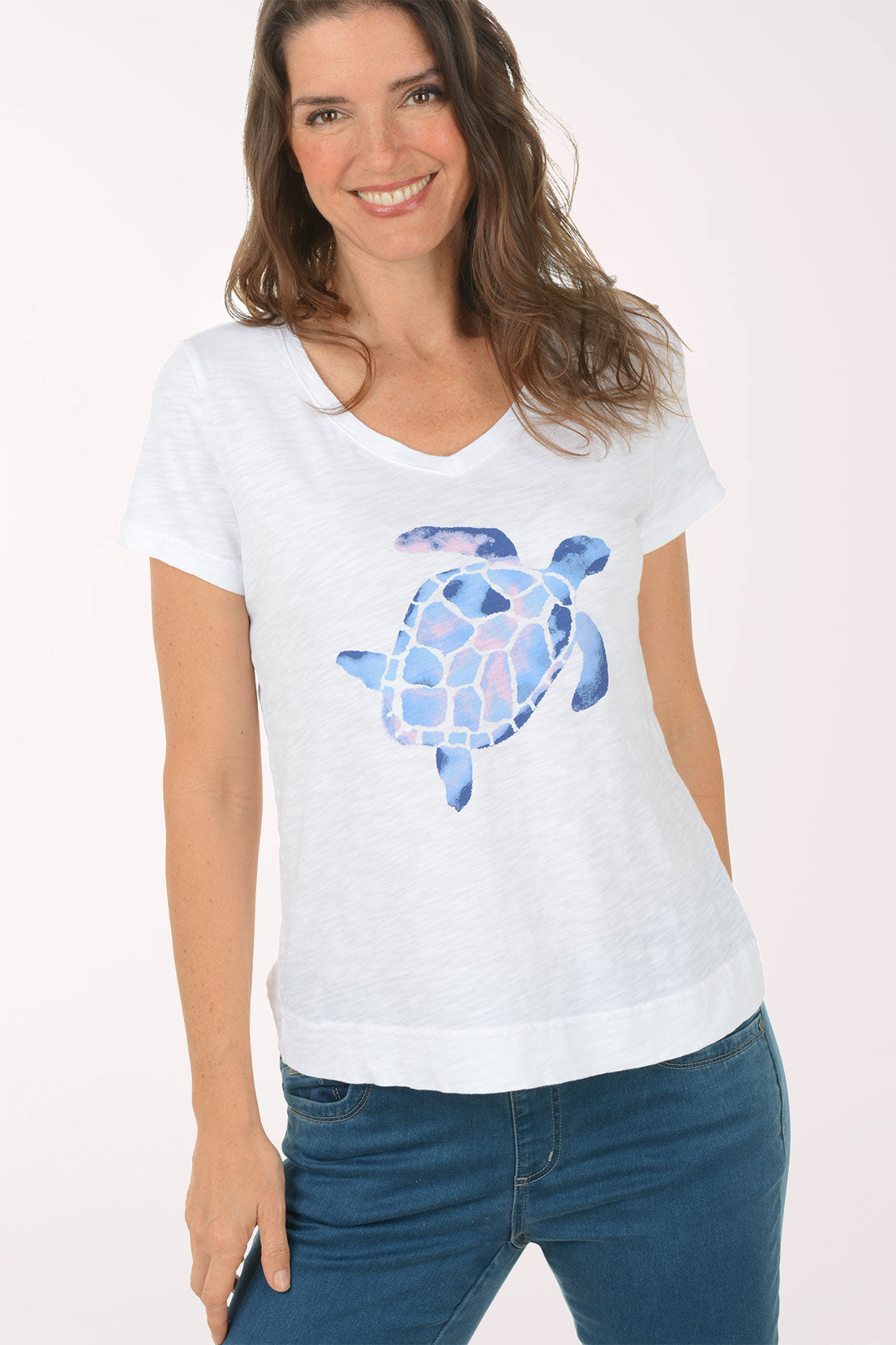 A woman wearing a short sleeve white top with a turtle print.