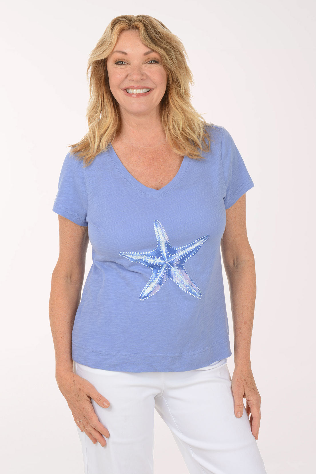 A woman wearing a short sleeve blue top.