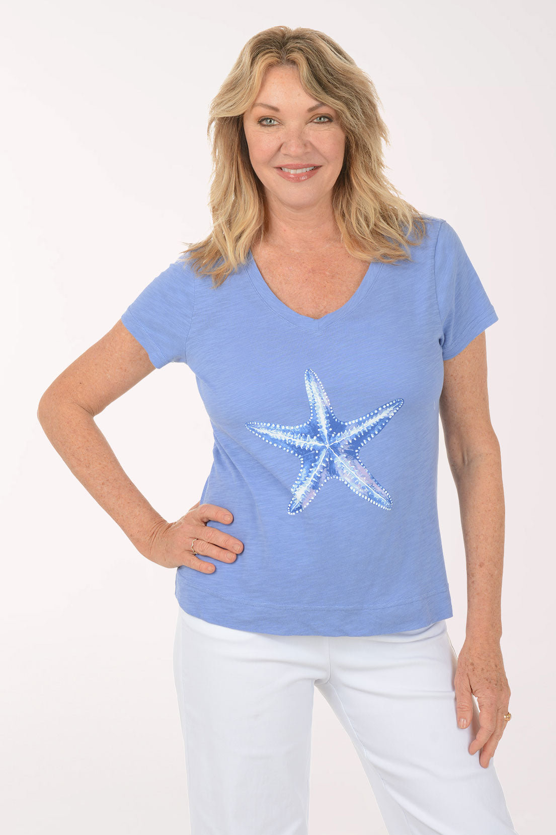 A woman wearing a short sleeve blue top.