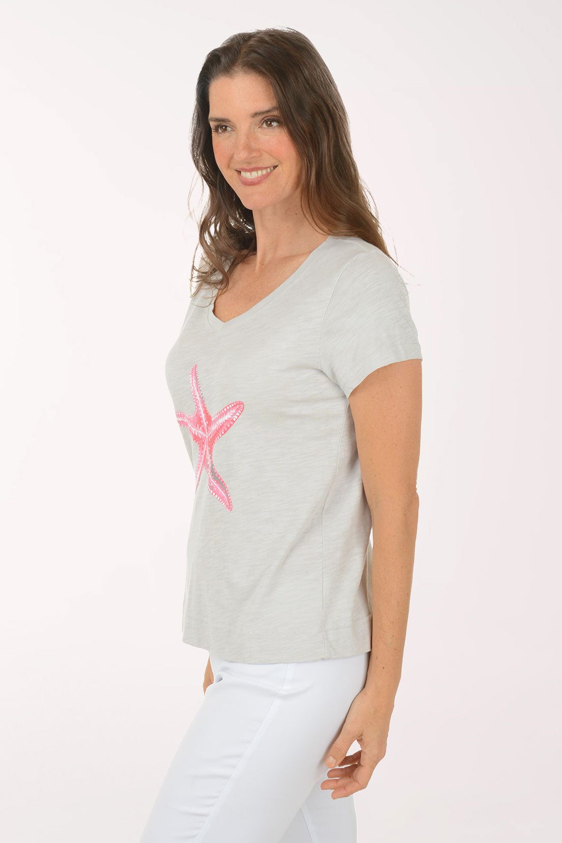 A woman wearing a short sleeve grey top.