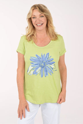 A woman wearing a short sleeve green top.