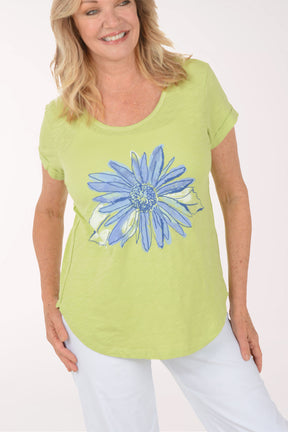 A woman wearing a short sleeve green top.