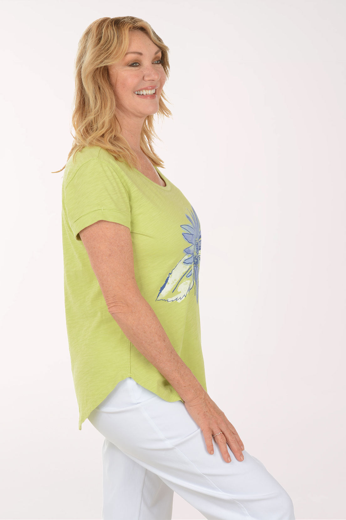 A woman wearing a short sleeve green top.