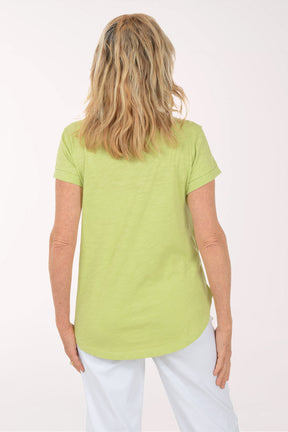 A woman wearing a short sleeve green top.